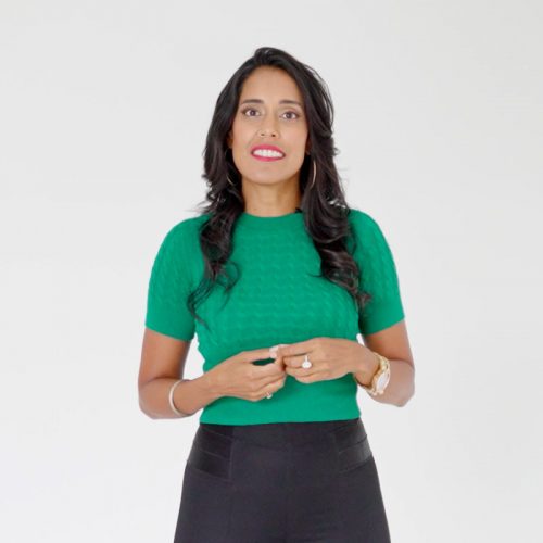 beplay体育手机Ritu Bhasin穿着亮绿色顶部和黑色底部。